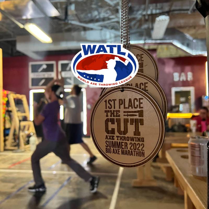 first place world axe throwing league medals with people throwing axes in the background